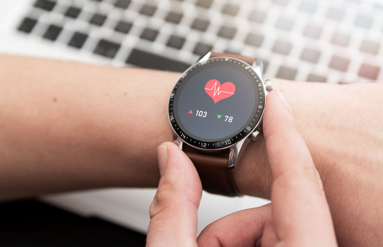 Hands with heart icon on smartwatch