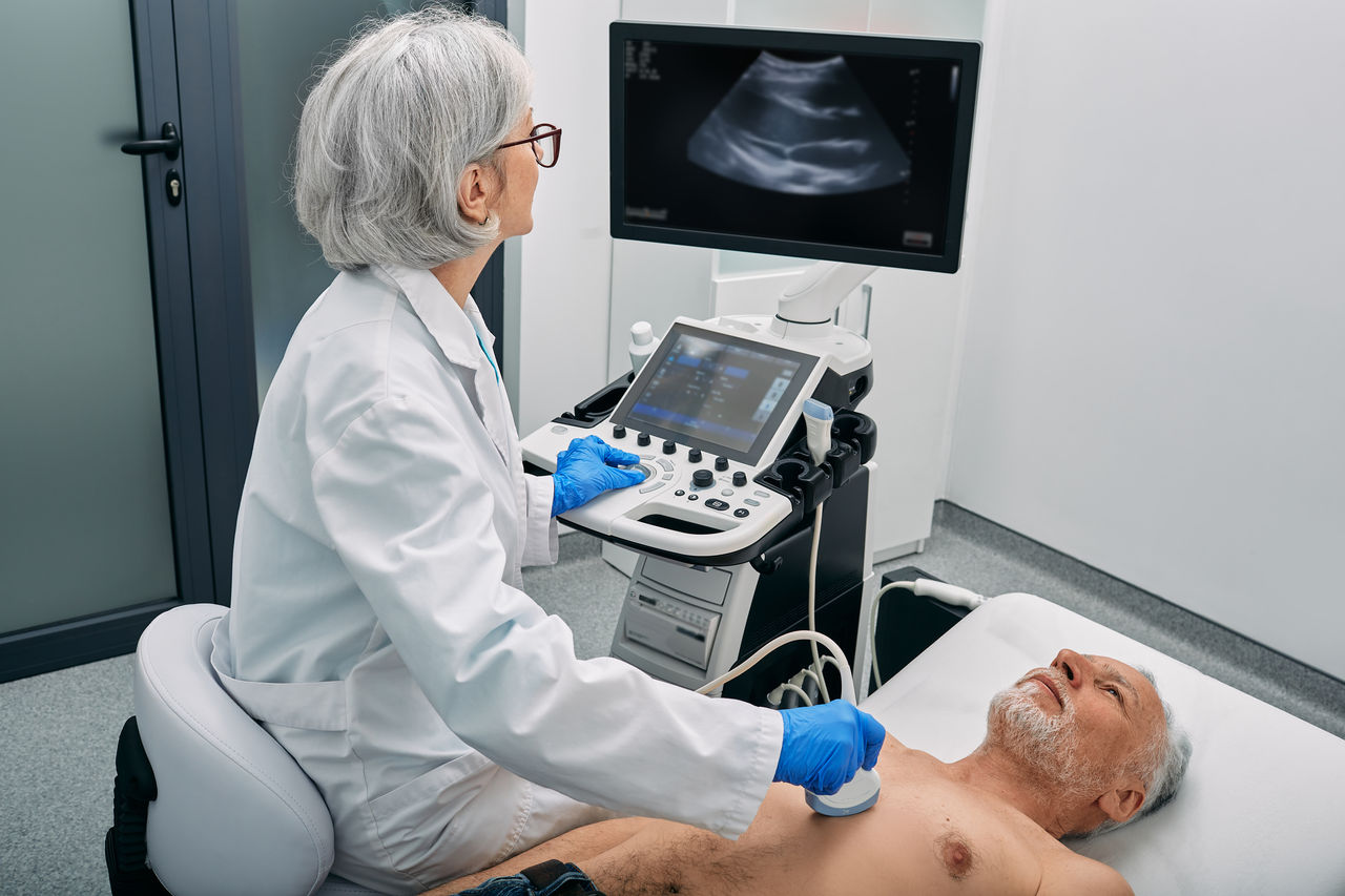 Heart ultrasound exam for senior man with ultrasound specialist while medical exam at hospital,Heart ultrasound exam for senior man with ultrasound specialist 
