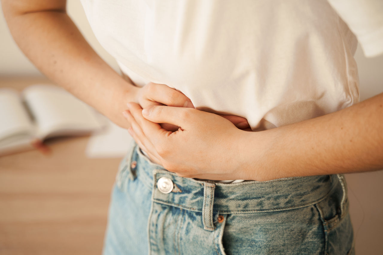 Stomach pain. Gastritis is an inflammation, irritation, or erosion of lining of stomach. Sick girl hold abdomen because it hurts.,Stomach pain. Gastritis is an inflammation, irritation, or erosi
