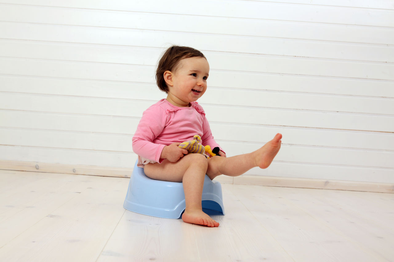 Ein Kleinkind sitzt auf einem Töpfchen