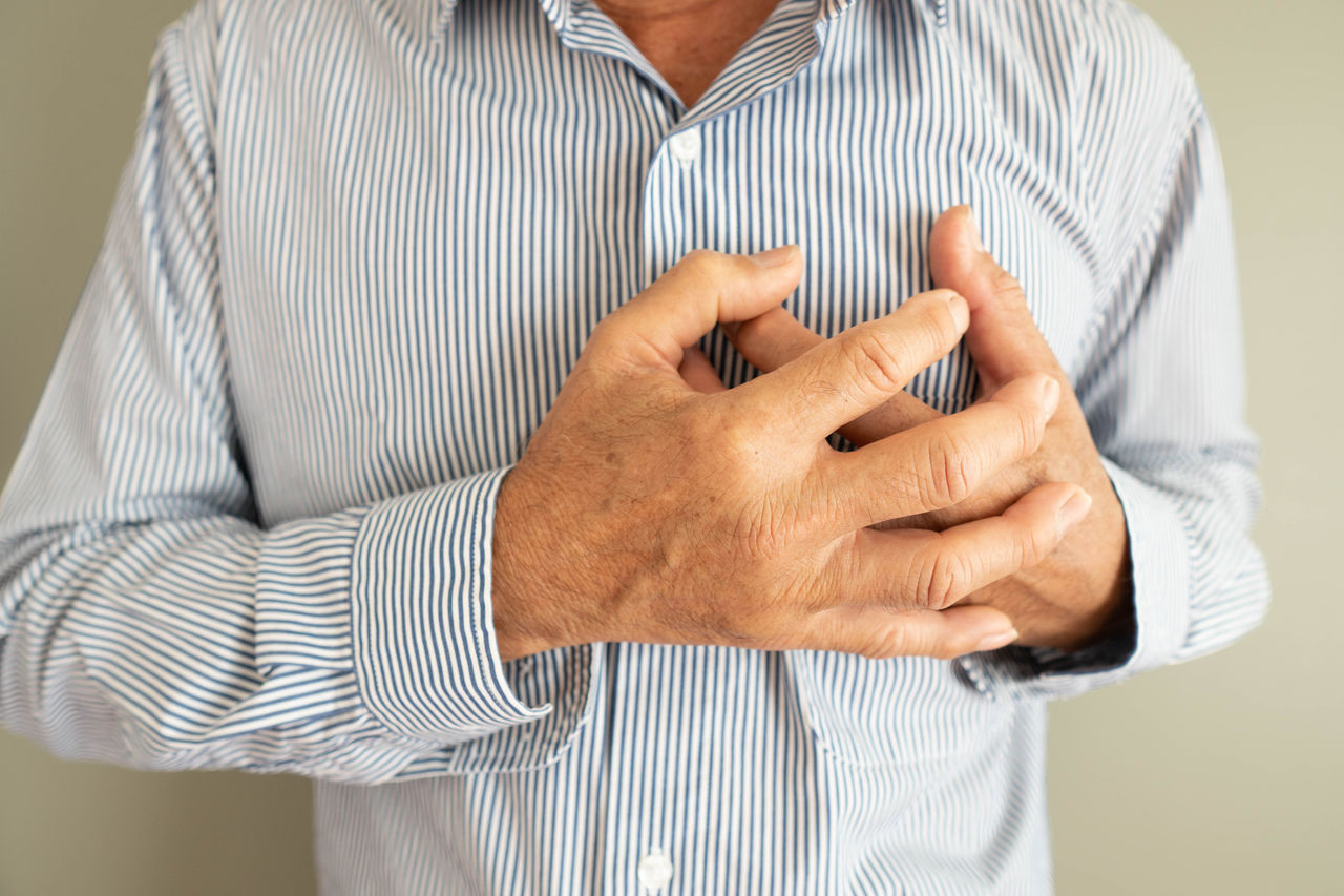 Heart attack problems. Elderly man suffering from severe chest pain. Warning signs of unstable angina or myocardrial infarction disease. Health care and cardiological concept. Close up.,Heart attack problems. Elderly man suffering from severe chest p