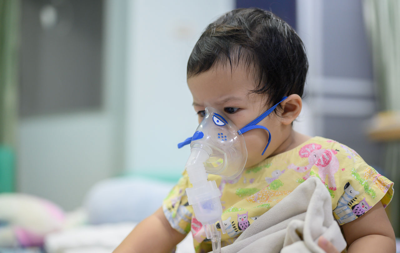 Asian baby was sick as Respiratory Syncytial Virus (RSV) in kid hospital. Thai little girl having inhaler containing medicine for stop coughing and disease flu.,Asian baby was sick as Respiratory Syncytial Virus (RSV) in kid 