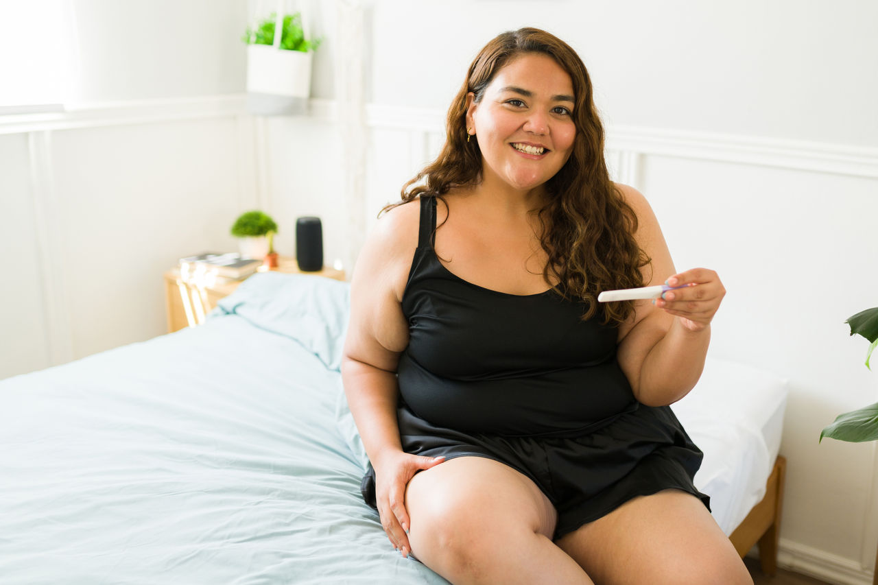 Excited pregnant overweight woman