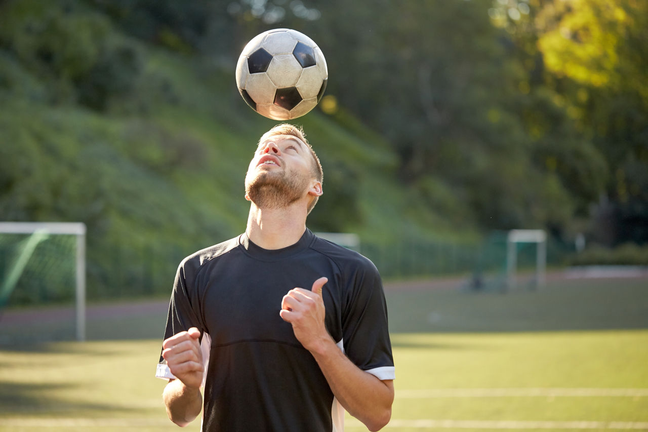 soccer player playing with ball on field