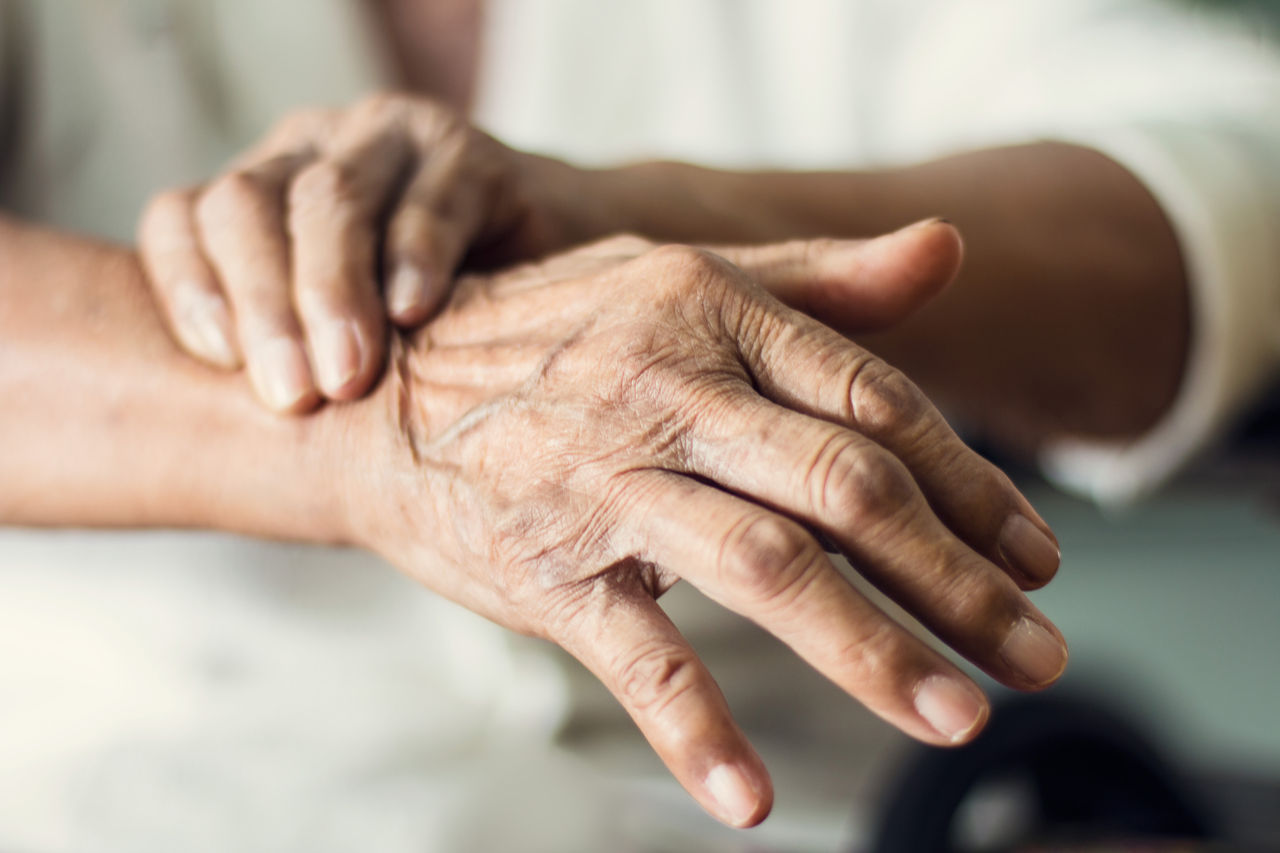 Close up hands of senior elderly woman patient suffering from pakinson's desease symptom. Mental health and elderly care concept,Close up hands of senior elderly woman patient suffering from pa